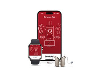 Apple watch and iPhone showing Bernafon App splash screen and a pair of hearing aids.